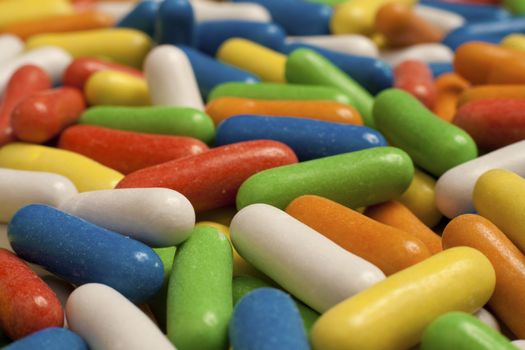 Multicolored Licorice Capsules. Macro studio shot with selective focus.