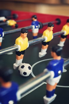 Close up of  a foosball game with soccer ball.