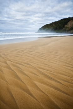 Beautiful beach of North Spain with waves  marks in the sand