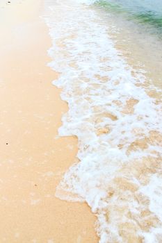 Soft wave of the sea on the sandy beach.