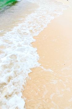 Soft wave of the sea on the sandy beach.