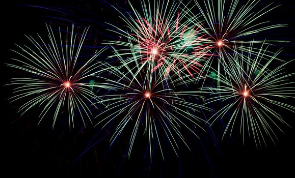 Exposure of multiple fireworks with a black sky.