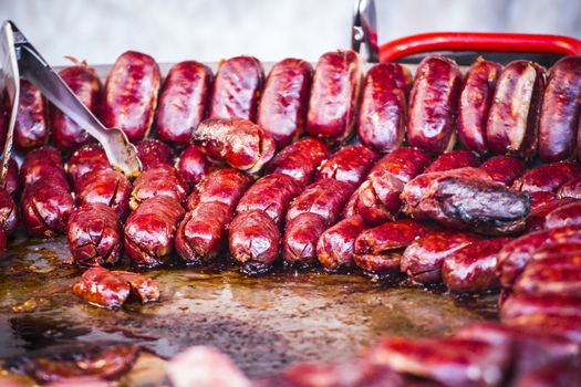 lots of sausages and chorizos in a medieval fair