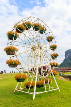 Flower pot is on the ferris wheel.