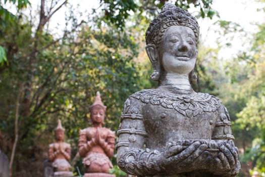 Thai monk, ancient statue holding alms bowl