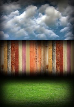 abstract colorful wood fence in backyard, natural backdrop with blue cloudy sky