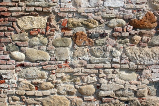ancient stone and red bricks  wall on medieval  fortress