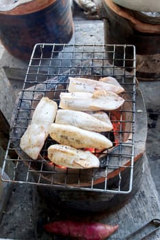 Cooking squid on the grill on the antique stove.