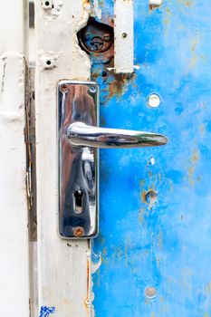 The old rusty latch of the home door.