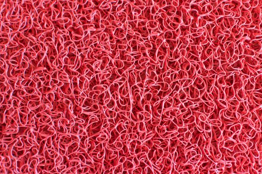 Texture background of the red plastic doormat.