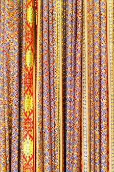 The colorful antique Thai fabric decorated as curtain.