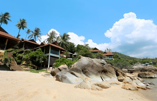 Landscape on the beach on a background of blue sky and houses