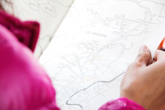 girl looking at map travel in japan