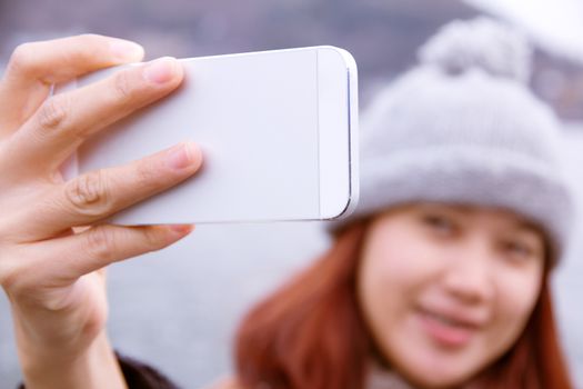 Happy young asian women are looking at her cellphone