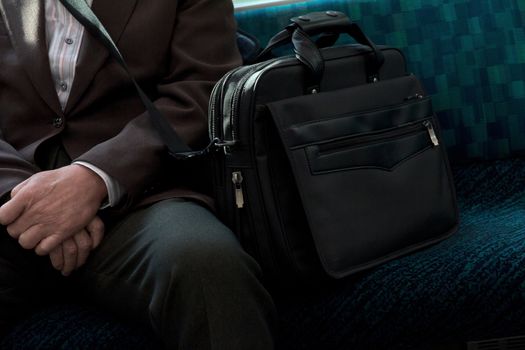 Japanese Businessmen sitting on seat in train
