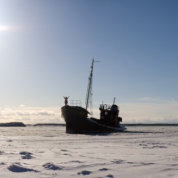 lonely ship in the snowy sea with a man dressed liuke bear onboard