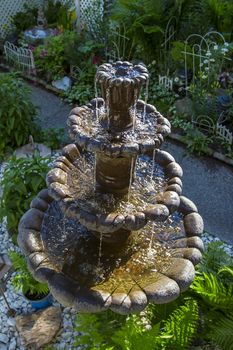 multi level concrete fountain in backyard garden