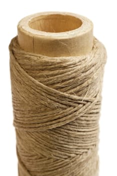 Hemp thread reel, vertical.  Macro studio shot.