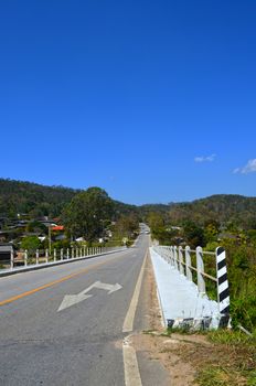 On Asphalt Road pass Country Village 1_1, Bridge, Direction, Traffic Sign, Maehongson province, Thailand