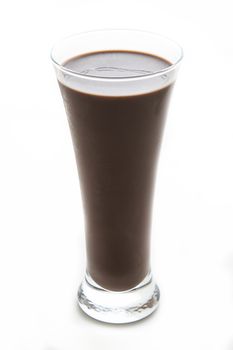 Chocolate milkshake in a slim glass against a white background