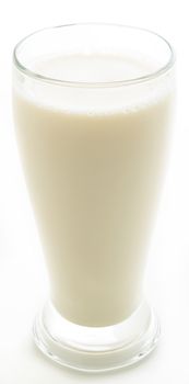 thick glass of milk against a white background