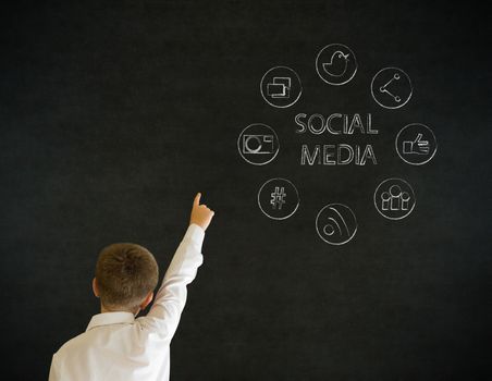 Hand up answer boy dressed up as business man with social media icons on blackboard background