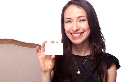 Girl holding blank business card template and smiling isolated on white