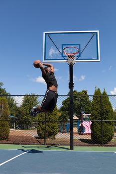 Young basketball player drives to the hoop with some fancy moves.