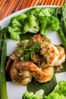 Shrimp scampi seafood dish with broccoli and asparagus.