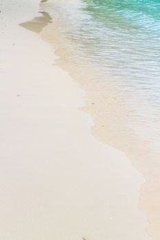 Soft wave of the sea on the sandy beach.