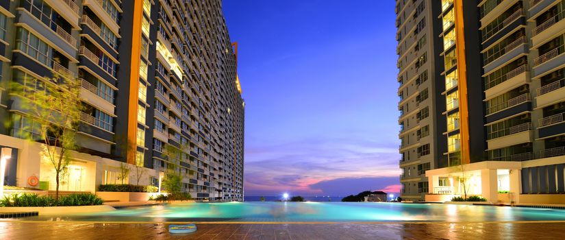 Modern apartments panorama with swimming pool at sunset in Pattaya Thailand