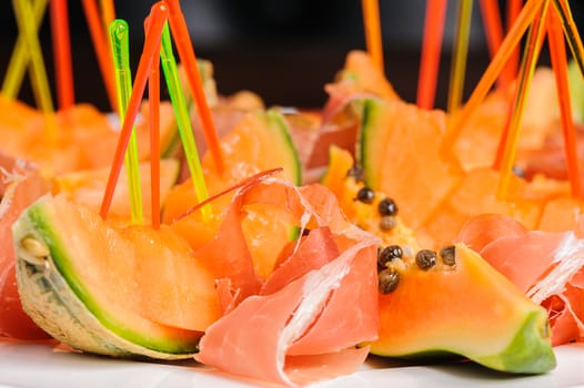 exotic mediterranean salad or dessert with prosciutto and papaya