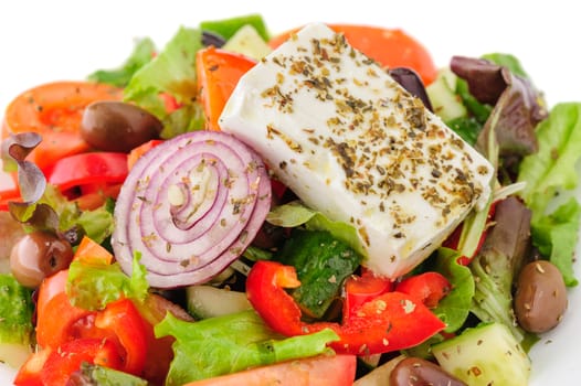 closeup of greek salad with large piece of feta