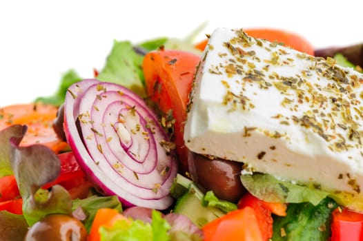 closeup of greek salad with large piece of feta