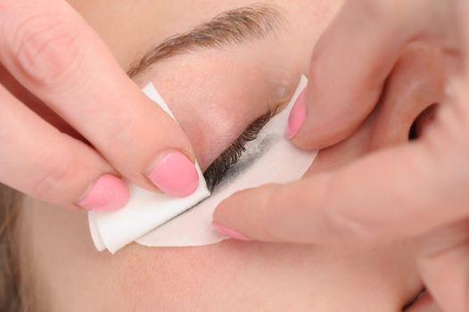 wiping mascara from eyelashes before facial mask applying