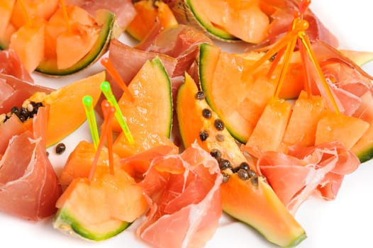 exotic mediterranean salad or dessert with prosciutto and papaya