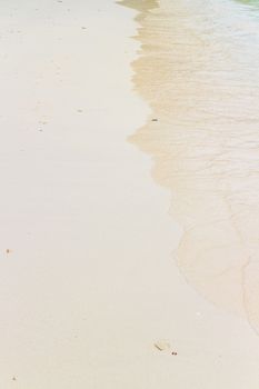 Soft wave of the sea on the sandy beach.