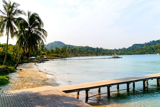 Wooden bridge on the way to the harbor. Sea view.