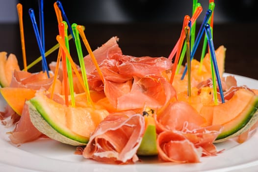 exotic mediterranean salad or dessert with prosciutto and papaya