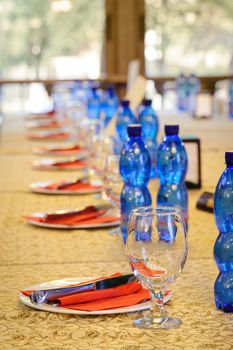 official banquet table with empty dishes and glasses at beginning