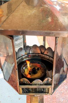 Light with oil lantern at Thai temple.