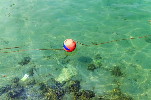 The red buoy on the sea water.
