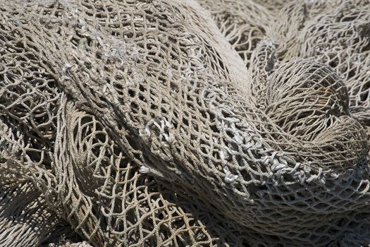 Close up of brown and white fishing net in the harbor