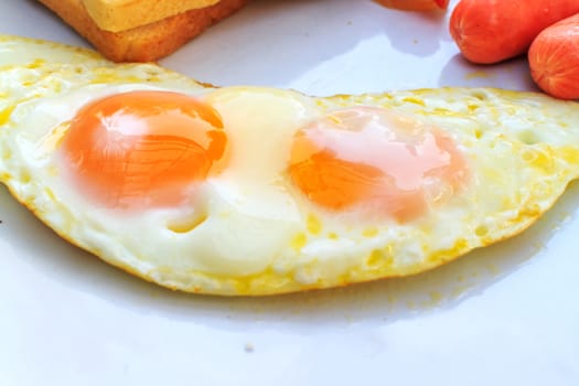 Breakfast with fried eggs, Sausage, toasts. Closeup.