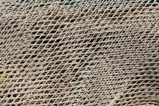 Close up of brown and white fishing net in the harbor