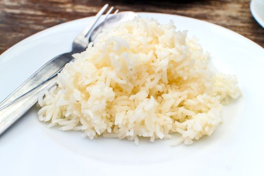 Steamed rice in a white dish ready to eat.