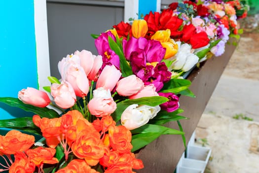 Fake multicolored tulips arranged beautifully planted.