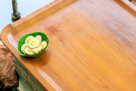 Fried Quail's egg in banana leaf cups, at outdoor market of Thailand.