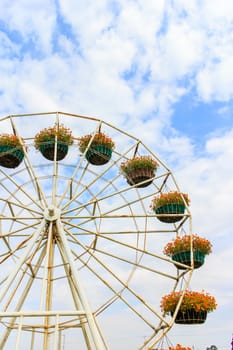 Flower pot is on the ferris wheel.