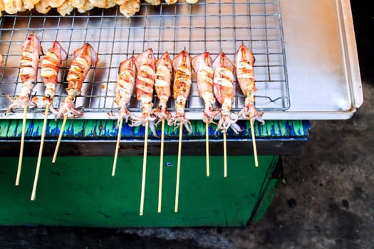 Many of grilled squid in thai market.